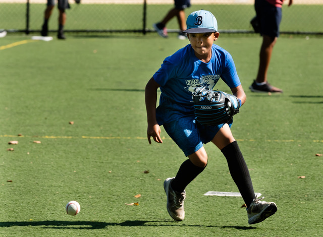Young player chasing ground ball