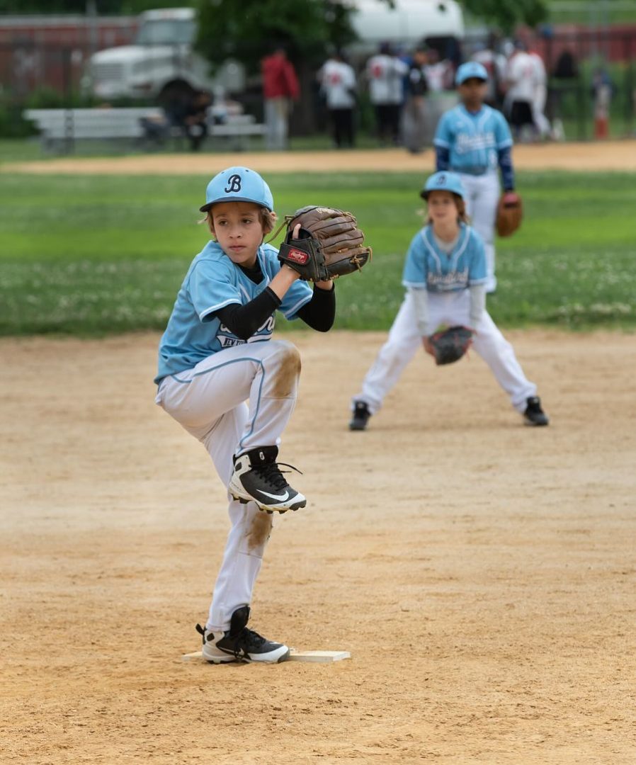 Youth baseball pitcher in blue uniform