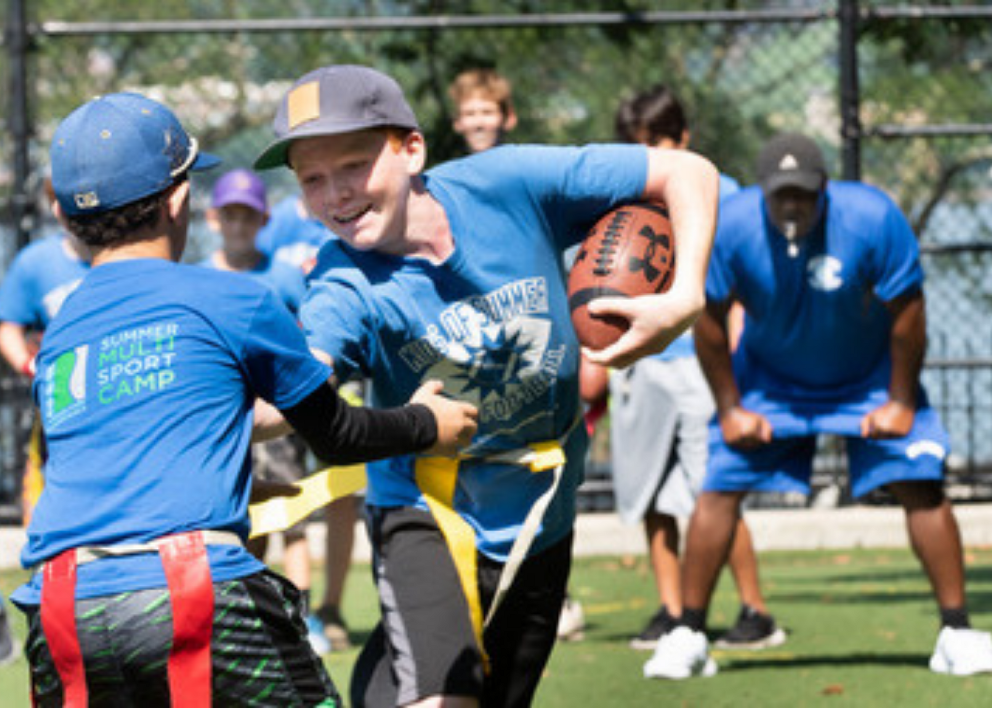 Kids playing flag football at summer camp